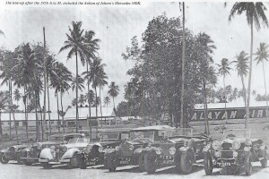 1956 AGM.. cars lined up outside. The Sultan’s 540K can be seen third from the left