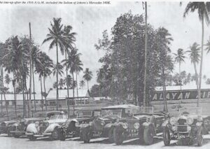1956 AGM.. cars lined up outside. The Sultan’s 540K can be seen third from the left